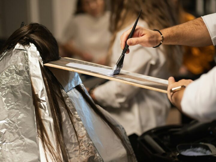 Colourist applying hair colour
