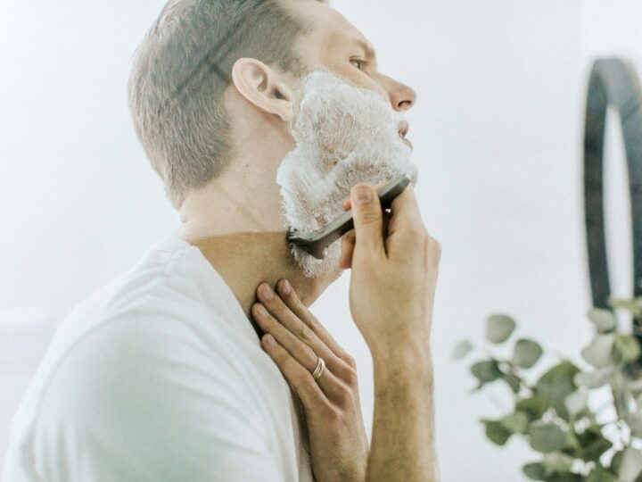Man wet shaving with a razor
