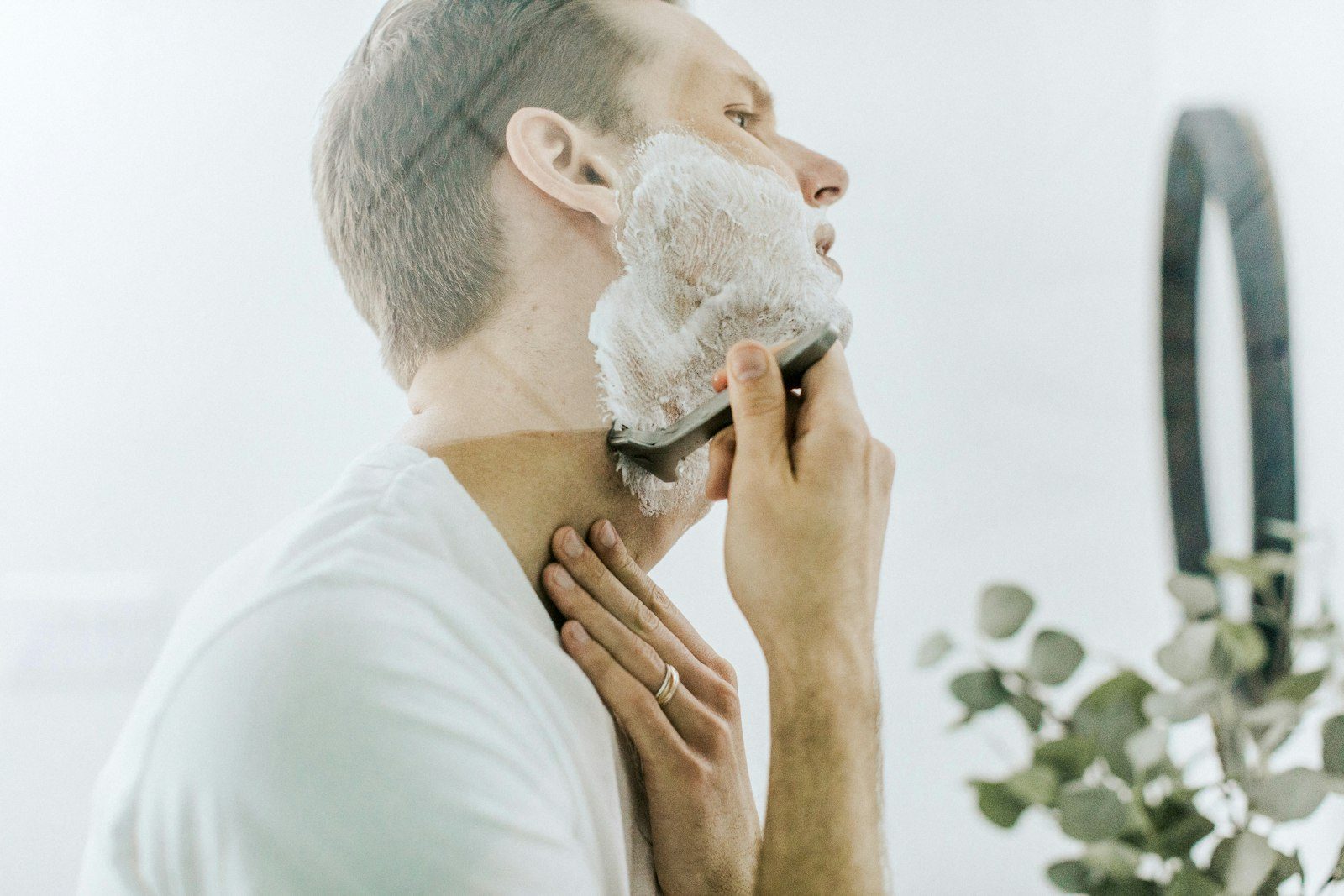 Man wet shaving with a razor