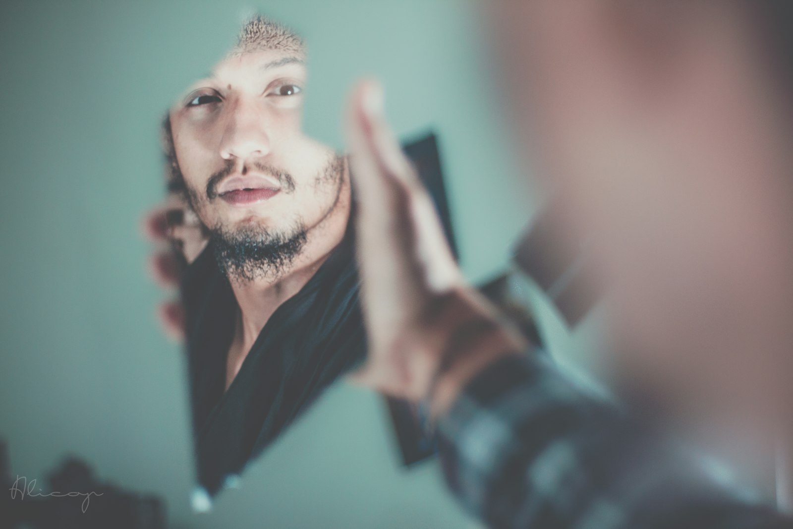 Man styling his hair at the mirror